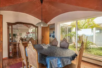 a dining room with a table and chairs and a kitchen at Villa Andrea in Albufeira