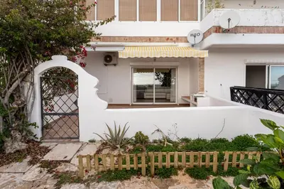 a white house with a fence at Estúdio 24 em Santa Bárbara de Nexe - Faro in Colmeal