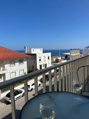 a table with two wine glasses on a balcony at TAC - Cerro Belo in Albufeira