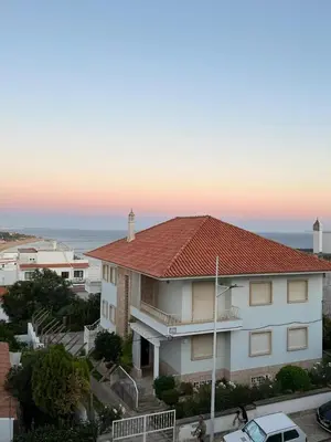 a white house with a red roof and the ocean at TAC - Cerro Belo in Albufeira
