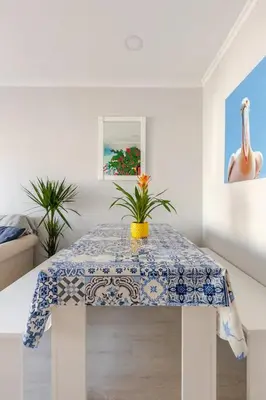a table with a blue and white table cloth on it at BrisaMarVilas Sea view, 5 min Walk to Town & Beach 12e13 in Albufeira