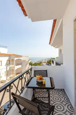 a balcony with a table with a meal on it at BrisaMarVilas Sea view, 5 min Walk to Town & Beach 12e13 in Albufeira