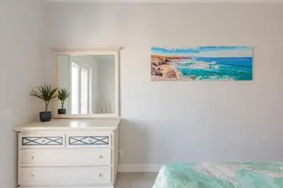 a bedroom with a white dresser and a mirror at BrisaMarVilas Sea view, 5 min Walk to Town & Beach 12e13 in Albufeira