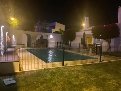 a swimming pool in front of a house at night at Luxury Villa private pool, Albufeira in Albufeira