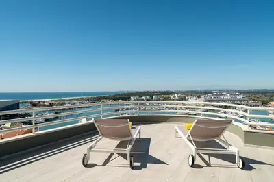 two chairs sitting on the roof of a cruise ship at Marina Mar Bela Vista by SAPvillas in Vilamoura