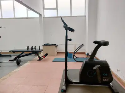 a gym with two exercise bikes and a treadmill at Marina Mar Bela Vista by SAPvillas in Vilamoura