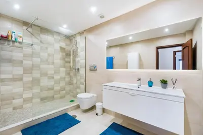 a bathroom with a sink and a toilet and a tub at Vivenda das Conchas - Just 50 Meters from the Beach in Quarteira