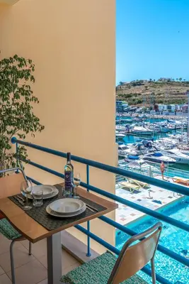 a balcony with a table and a view of a marina at Luxury 1 Bedroom Apartment, Marina de Albufeira4 in Albufeira