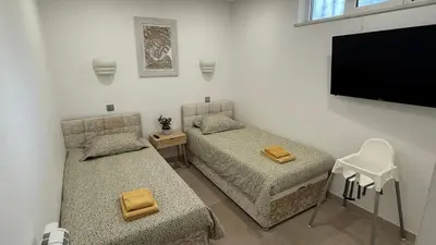 a bedroom with a bed and a desk and a television at Sunny 3-Bedroom Apartment in Albufeira