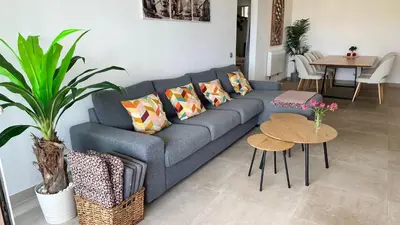 a living room with a large flat screen tv at Sunny 3-Bedroom Apartment in Albufeira