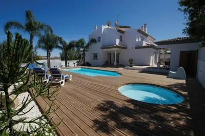 a backyard with a swimming pool and a house at Villa Perla in Guia
