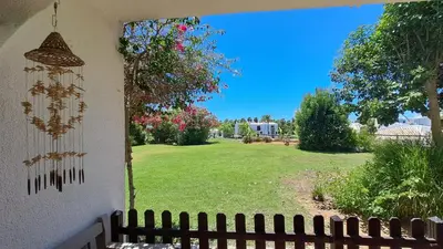 a view of a yard with a fence and a garden at SÃO RAFAEL BEACH Apartment 55 in Albufeira