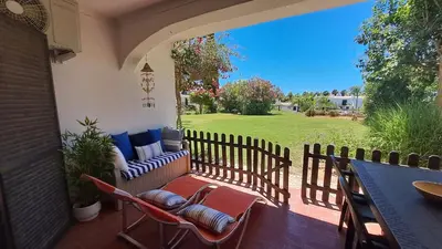 a patio with chairs and a table and a fence at SÃO RAFAEL BEACH Apartment 55 in Albufeira