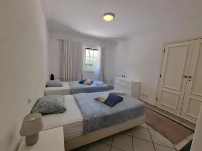 a bedroom with two beds and a window at Charming Villa Albufeira in Albufeira