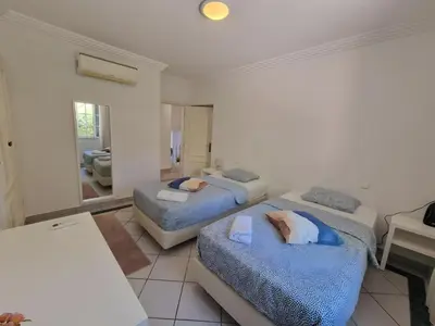 a bedroom with two beds with pillows on them at Charming Villa Albufeira in Albufeira