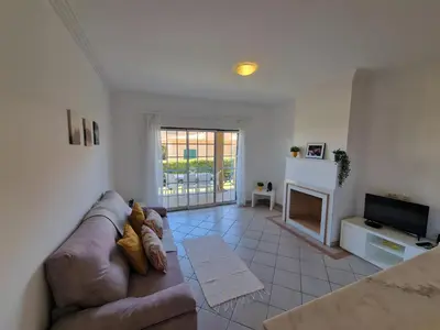 a living room with a couch and a fireplace at Charming Villa Albufeira in Albufeira