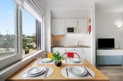 a kitchen with a table with plates on it at Sun and Serenity in Albufeira