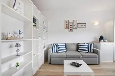 a living room with a couch and a table at Sun and Serenity in Albufeira