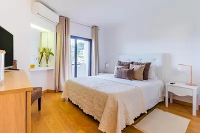 a living room with a couch and a coffee table at Albufeira Sunny Days | Pool View Family Apartment in Albufeira