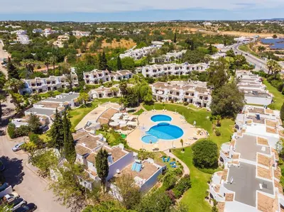 a living room with a couch and a table at Albufeira Sunny Days | Pool View Family Apartment in Albufeira