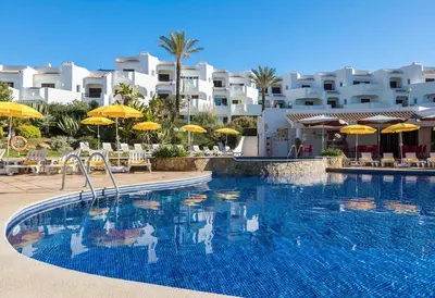 a kitchen and dining room with a table and chairs at Albufeira Sunny Days | Pool View Family Apartment in Albufeira
