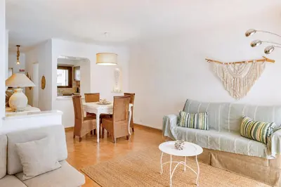 a table and chairs on a patio with a pool at Albufeira Sunny Days | Pool View Family Apartment in Albufeira