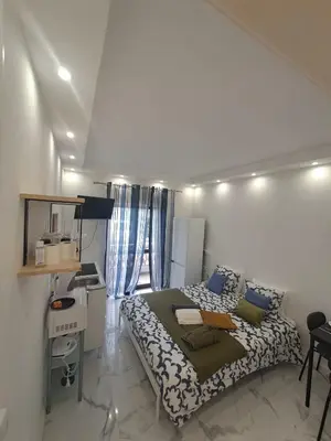 a small bedroom with a bed and a desk at Albufeira studio in Albufeira