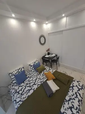 a bedroom with a large bed and a table at Albufeira studio in Albufeira