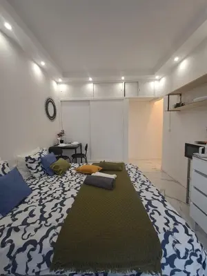 a large bed in a room with a large rug at Albufeira studio in Albufeira