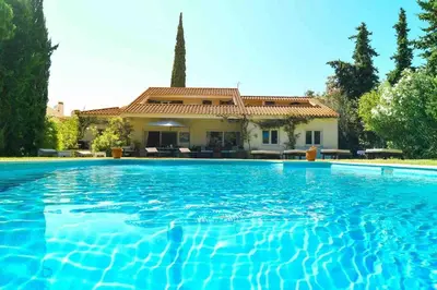 a large swimming pool in front of a house at Vale do Lobo 5 Bed Villa with Large Pool overlooking Golf Course in Almancil