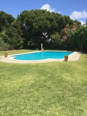 a swimming pool in the middle of a yard at Vale do Lobo 5 Bed Villa with Large Pool overlooking Golf Course in Almancil