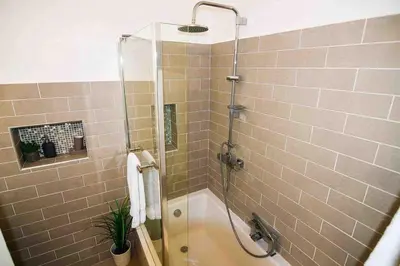 a bathroom with a shower with a bath tub at Vale do Lobo 5 Bed Villa with Large Pool overlooking Golf Course in Almancil