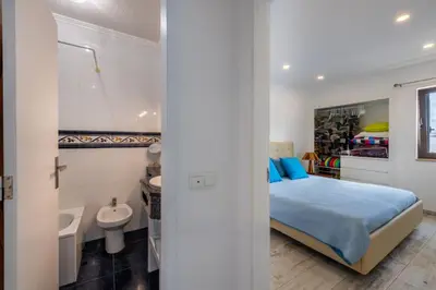 a bedroom with a bed and a bathroom with a sink at Albufeira View Sea Apartment Luxury in Albufeira