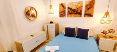 a small bedroom with a blue bed and a dresser at Albufeira View Sea Apartment Luxury in Albufeira