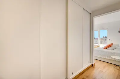 a bedroom with white walls and a large mirror at Apart OCEAN DRIVE - Oura - Jacuzzi - BY BEDZY in Albufeira