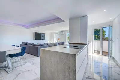 a kitchen and living room with a couch and a table at Apart OCEAN DRIVE - Oura - Jacuzzi - BY BEDZY in Albufeira