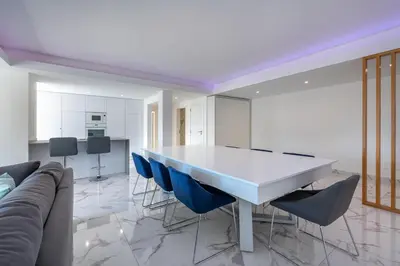 a dining room with a white table and blue chairs at Apart OCEAN DRIVE - Oura - Jacuzzi - BY BEDZY in Albufeira