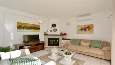 a patio with two chairs and a swimming pool at Villa Den, private pool villa, Sleeps 6 adults and 2 children, CD 304 - Cleverdetails in Vilamoura