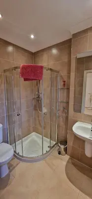 a bathroom with a shower and a toilet and a sink at Villa Cristina in Quarteira