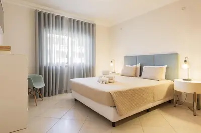a bedroom with a bed with a teddy bear on it at Praia Village I - Peaceful condominium by HD in Vilamoura