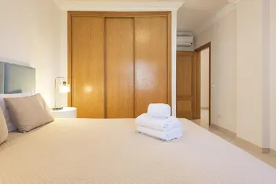 a bedroom with a bed with white towels on it at Praia Village I - Peaceful condominium by HD in Vilamoura