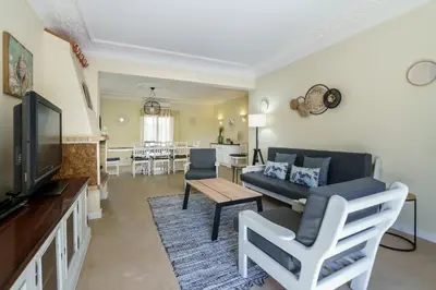 a living room with a couch and a tv at Villa Lucio by SAPvillas in Vilamoura