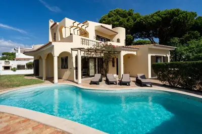 a villa with a swimming pool in front of a house at Villa Lucio by SAPvillas in Vilamoura