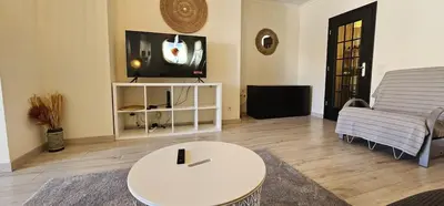 a living room with a white table and a couch at Green Balcony Holiday Work Remote Big Apartment in Albufeira