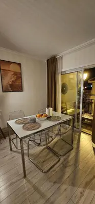 a table and chairs in a room with a living room at Green Balcony Holiday Work Remote Big Apartment in Albufeira