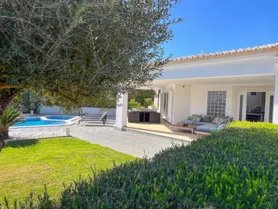 a backyard with a pool and a house at Beautiful 4-Bedroom Villa with Garden and Pool in Albufeira