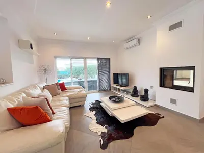 a living room with a couch and a table at Beautiful 4-Bedroom Villa with Garden and Pool in Albufeira