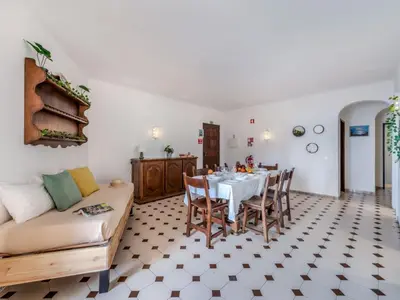 a kitchen with a living room with a table and chairs at Apartment T3 capricórnio - VIP Properties by Interhome in Galé