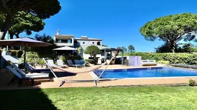 a patio with a table and chairs under a pergola at Villa Linda Rosa, CD 302 by Cleverdetails private pool, prime location in Vilamoura