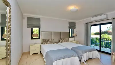 a bedroom with a bed and a mirror at Villa Linda Rosa, CD 302 by Cleverdetails private pool, prime location in Vilamoura